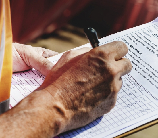 Surveyor completing property report